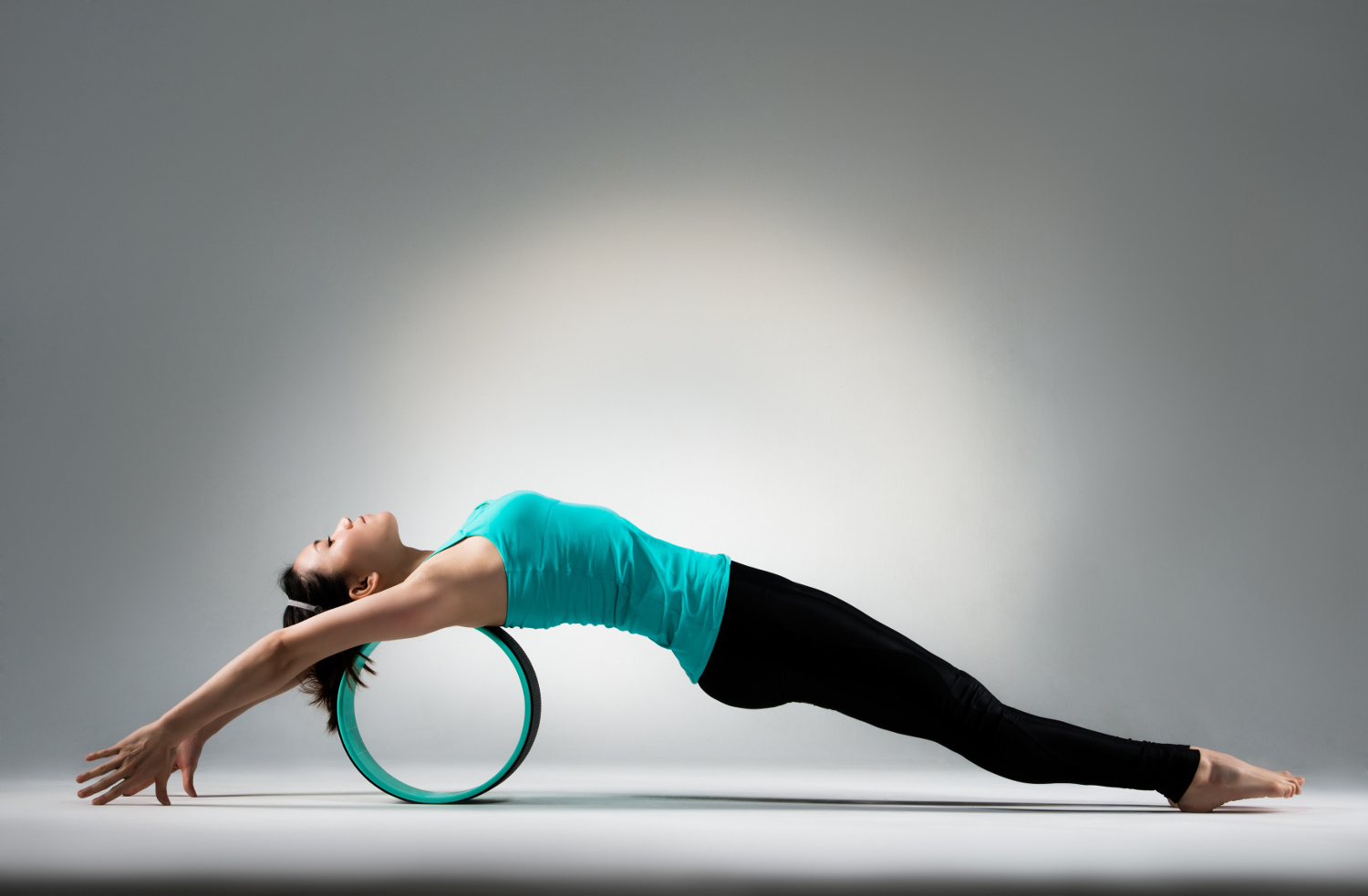 Pilates wheel being used to increase flexibility by lengthening the muscles